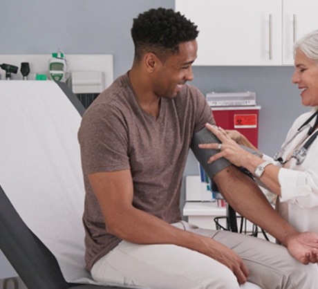 Doctor taking patient’s blood pressure