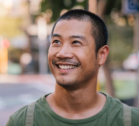 Man smiling on street