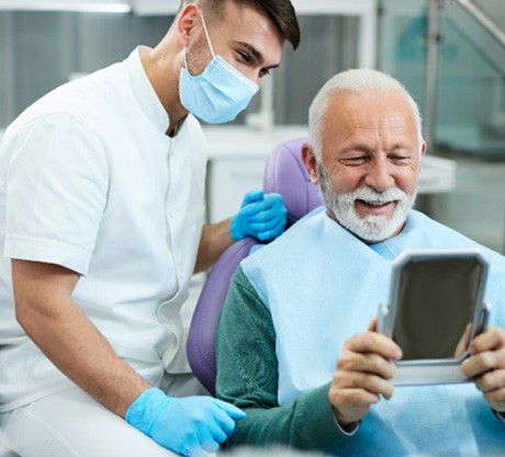 patient smiling after receiving dental implants  