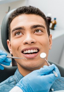 patient smiling while getting dental checkup 