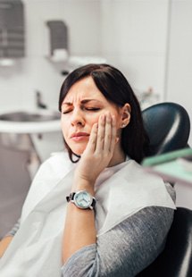 woman in pain visiting emergency dentist 