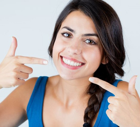 a patient smiling after receiving teeth whitening